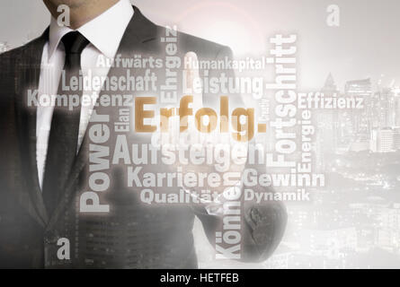 Businessman with urban background Erolg (in german success) wordcloud. Stock Photo