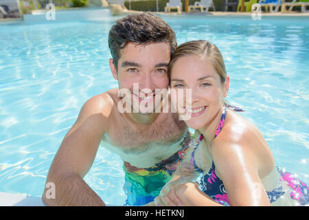 Premium Photo | High angle view of happy young couple by the pool. couple  are relaxing at swimming pool party. summer vacation concept