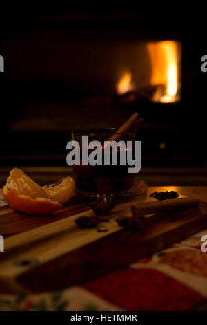 Preparing and drinking mulled wine in front of the fireplace Stock Photo