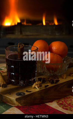 Preparing and drinking mulled wine in front of the fireplace Stock Photo