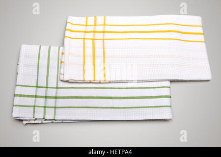Two White Tablecloth made of cotton with green and yellow stripes for the dish on a gray gradient background isolated Stock Photo
