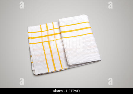White Tablecloth made of cotton with yellow stripes for the dish on a gray gradient background isolated Stock Photo