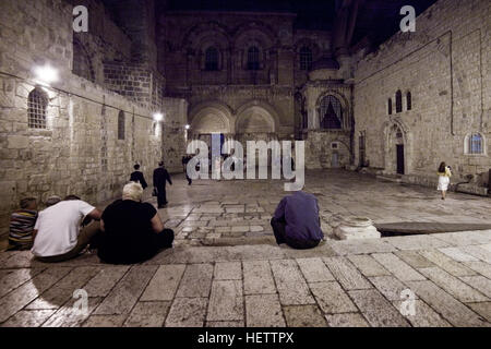 Jerusalem, Israel - July 12, 2014: Pilgrims rest at the main courtyard in front of the Church of the Holy Sepulchre in Jerusalem.     All privileges a Stock Photo