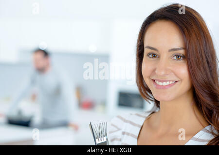 Wife letting her husband cook Stock Photo - Alamy