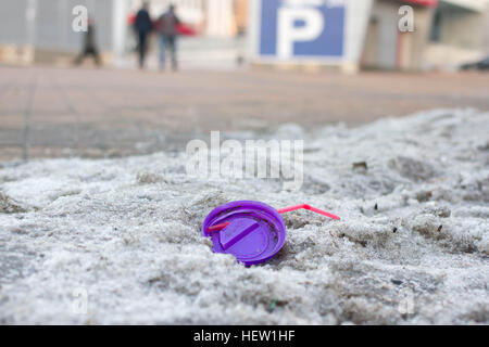One compressed plastic bottle isolated. Waste in cityscape Stock Photo
