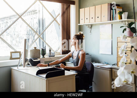 Woman in office using computer Stock Photo