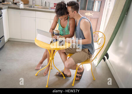 Couple at table using digital tablet Stock Photo