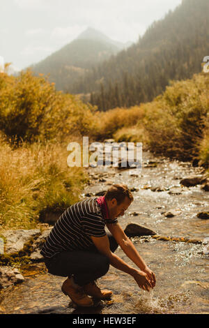 Man washing hands in creek, Mineral King, Sequoia National Park, California, USA Stock Photo