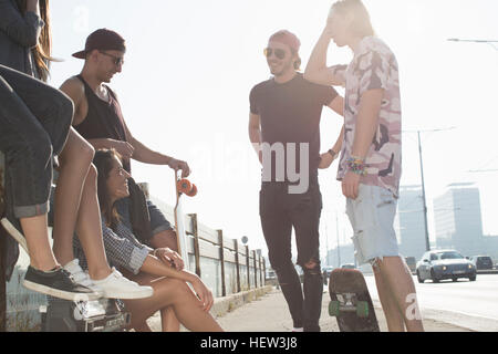 Skateboarders standing and talking, Budapest, Hungary Stock Photo