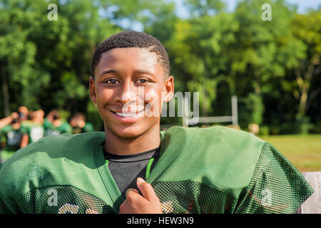 Portrait teenage male American football player at playing field Stock Photo