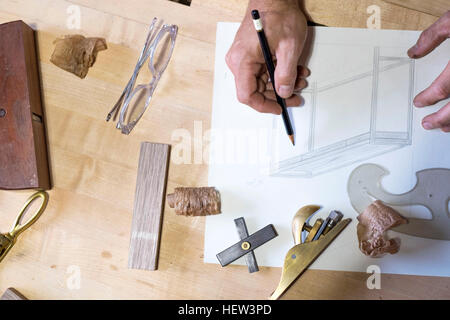 Carpenter at his workshop, close up view of hand drawing Stock Photo