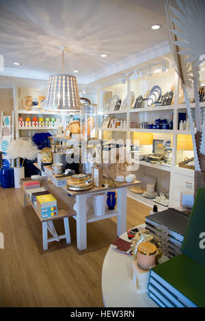 Shelves with china, books and ornaments in boutique Stock Photo