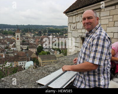 An American tourist looking over quaint Schaffhausen, Switzerland, from Munot Castle on a cloudy Swiss day. Stock Photo