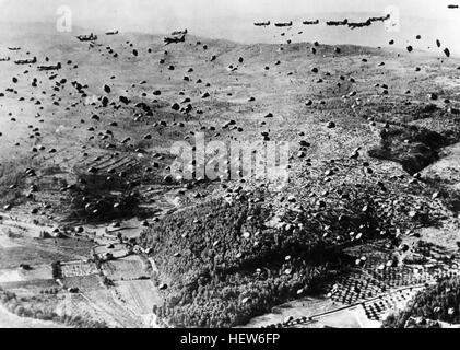 OPERATION DRAGOON 15 August 1944. Paratroopers from the  Ist Airborne Task Force dropping from Dakotas on one of the three RUGY drop zones inland while Allied naval landings attacked from the coast seen towards top of picture. Photo: US Signal Corps Stock Photo