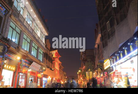 People visit Beijing Hutong street in Beijing China. Hutongs are a type of narrow streets or alleys, commonly associated with northern Chinese cities. Stock Photo