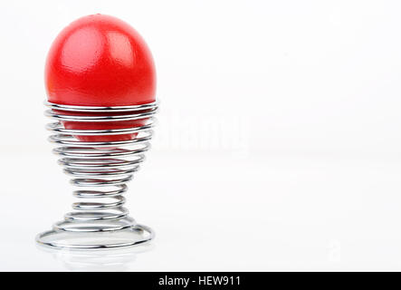 Red Easter egg in a spiral eggcup Stock Photo