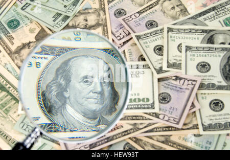 US dollar bills, banknotes, cash under a magnifying glass Stock Photo