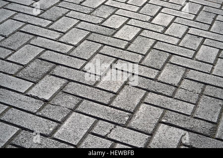 Closeup of paved sidewalk with grey stone bricks Stock Photo