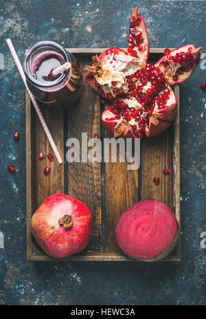Ripe seasonal pomegranates, beetroot and freshly squeezed juice in glass Stock Photo