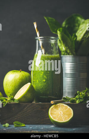 Green smoothie in bottle with apple, romaine lettuce, lime, mint Stock Photo