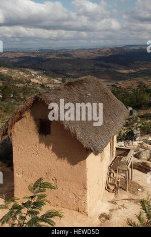 Hilltop mud brick thatched farmhouse to the south of Ambositra, Madagascar Stock Photo