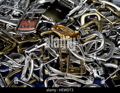 Buckles are fastening devices that secure two ends together, often used in belts and other items. Their design has evolved over time, and they remain an essential tool for securing various products. From fashion to utility, buckles serve both functional and aesthetic purposes. Stock Photo