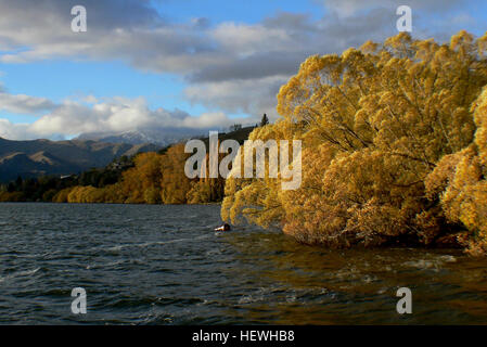 Lake Hayes is a small lake in the Wakatipu Basin in Central Otago, in New Zealand's South Island. It is located close to the towns of Arrowtown and Queenstown. Stock Photo