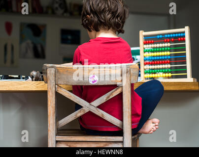 Boy doing his homework at home Stock Photo