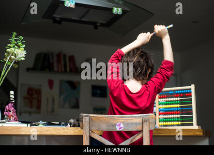 Boy doing his homework at home Stock Photo
