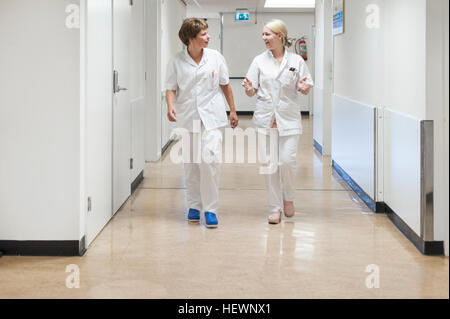 Nurses walking in hospital corridor Stock Photo