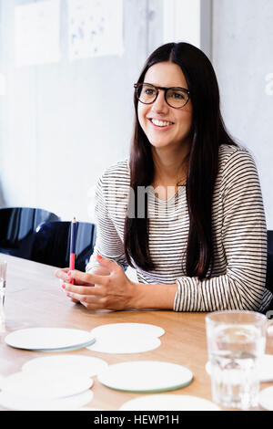 Portrait of woman in conference room looking away smiling Stock Photo