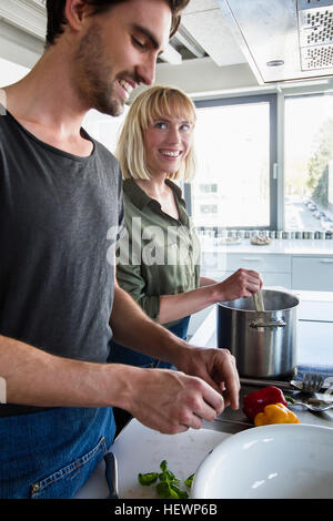 Couple in kitchen cooking Stock Photo