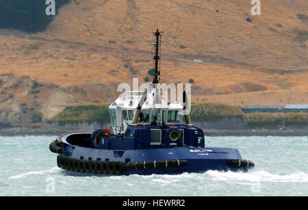 Tug Blackadder. Lyttleton NZ.  Replacing the 25 year-old Godley, designed by Robert Allan of Vancouver, built by Titan Marine Engineering at Auckland and named after the Rugby player Todd Blackadder, the 23.8 metre, $7 million, Blackadder was the most powerful harbour tug in New Zealand when she arrived at Lyttelton in September, 2002  Powered by twin Caterpillar Diesels, she's driven by Rolls-Royce Azimuthing stern thrusters. Operated by two crew, the tug has a small pantry and mess area in the wheelhouse, with two staterooms and a spacious lounge below the main deck. Stock Photo