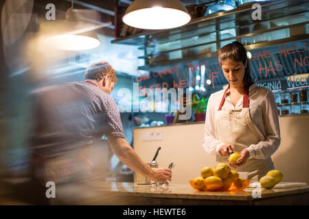 Restaurant owners working in kitchen Stock Photo