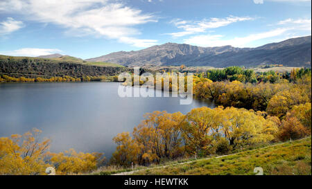 Lake Hayes is a small lake in the Wakatipu Basin in Central Otago, in New Zealand's South Island. It is located close to the towns of Arrowtown and Queenstown. Stock Photo