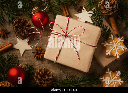Christmas present wrapped in kraft paper with natural decoration Stock Photo