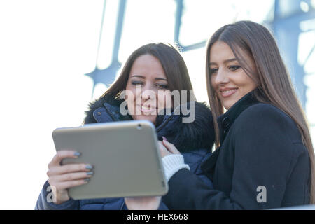 Two young business women with a tablet in hand Stock Photo