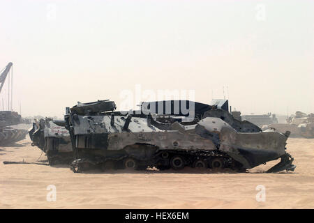 A heavily damaged US Marine Corps (USMC) Amphibious Assault Vehicles (AAV7A1) equipped with a mine plow, waits shipment at Camp Fox, Kuwait during Operation IRAQI FREEDOM. The Vehicle was reportedly destroyed by friendly fire. Destroyed US military vehicles in Iraq Stock Photo