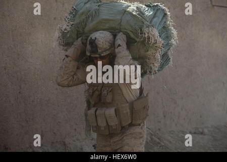 MUSA QALEH, Helmand province, Islamic Republic of Afghanistan – Staff Sgt. Jason Pickens, 32, a platoon guide from Redmond, Oreg., carries a load of sandbags at a small combat outpost in Musa Qaleh, Nov. 2, 2010. Immediately after arriving, engineers with 1st Combat Engineer Battalion, 1st Marine Division (Forward), got to work improving defensive positions manned by 1st Battalion, 8th Marine Regiment. (U.S. Marine Corps photo by Cpl. John M. McCall) Engineers improve 1-8's defense in Musa Qal'eh DVIDS338908 Stock Photo