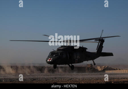 MUSA QAL’EH, Helmand province, Islamic Republic of Afghanistan – A Blackhawk helicopter takes off after collecting two Afghan men suffering from gunshot wounds outside of a patrol base in Musa Qal’eh, Dec. 20, 2010. Marines with 1st Combat Engineer Battalion, 1st Marine Division (Forward), were constructing a defensive position when two locals asked for medical attention after being involved in a gunfight. (U.S. Marine Corps photo by Cpl. John M. McCall) 1st CEB corpsmen provide medical attention to local Afghans DVIDS358108 Stock Photo