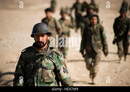 KABUL, Afghanistan (Jan. 12, 2011) – Afghan National Army recruits walk back to their formation after completing marksmanship training during Basic Warrior Training in Kabul Military Training Center Jan. 12, 2011. At the center which is the largest training base in Afghanistan, NATO Training Mission - Afghanistan advisers help and advise Afghan National Army instructors who teach the bulk of the recruits training. (U.S. Navy photo by Petty Officer 2nd Class Ernesto Hernandez Fonte/RELEASED) Flickr - DVIDSHUB - Afghan National Army Recruits in Basic Warrior Training (Image 2 of 2) Stock Photo