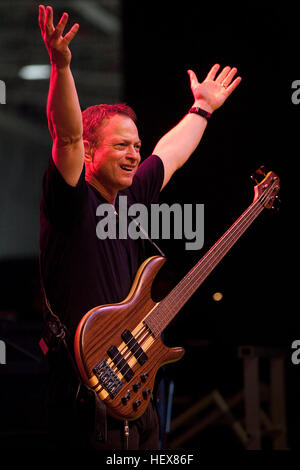 Actor and producer Gary Sinise, best known for his roles as Army 2nd Lt. Dan Taylor in the 1994 Academy Award-winning movie 'Forrest Gump,' and Detective Mac Taylor in the TV show 'Crime Scene Investigation: New York,' pumps up the crowd during a United Service Organizations-sponsored Lt. Dan Band concert at Hangar 103 on Marine Corps Base Hawaii, Feb. 11, 2011. While the band's mission to entertain remained unchanged from past performances at MCB Hawaii, this visit focused on advocating the Marine Corps' new DSTRESS Line -- 'a place to call for those with the courage to answer our nation's ca Stock Photo