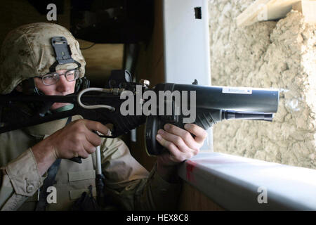 US Marine Corps (USMC) Corporal (CPL) Luke Schemenauer, assigned to Headquarters Company, 6th Marine Regiment, fires a .68 caliber FN 303 Less Lethal System launcher during a training exercise inside the Military Operations in Urban Terrain (MOUT) facility at Bagram Air Base (AB), Afghanistan, during Operation ENDURING FREEDOM. FN 303 Stock Photo