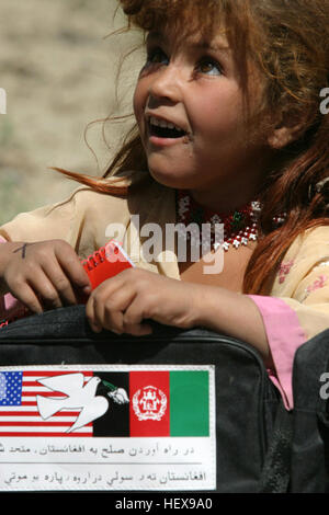 040513-M-8683D-008 Surobi, Afghanistan (May 13, 2004) - An Afghan girl carries school supplies given to her by U.S. Marines from Headquarters Company, 6th Marine Regiment. Marines and Sailors from the company frequently support security, stability and civil affairs operations in the region, while conducting missions in support of Operation Enduring Freedom (OIF). U.S. Marine Corps photo by Lance Cpl. James Patrick Douglas (RELEASED) US Navy 040513-M-8683D-008 An Afghan girl carries school supplies given to her by U.S. Marines Stock Photo