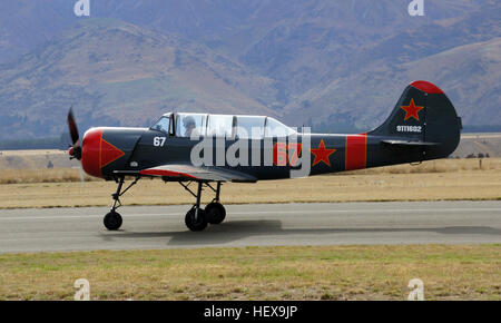 The Yakovlev Yak-52 (Як-52) is a Soviet primary trainer aircraft which first flew in 1976. It is still being produced in Romania by Aerostar, which gained manufacturing rights under agreement within the now defunct COMECON socialist trade organisation. The Yak-52 was designed originally as an aerobatic trainer for students in the Soviet DOSAAF training organisation, which trained both civilian sport pilots and military pilots.  Since the early 1990s and the fall of the Soviet Union, many Yak 52s have been exported to the west. Of the approximately 1,800 produced to date, most now fly in the Un Stock Photo