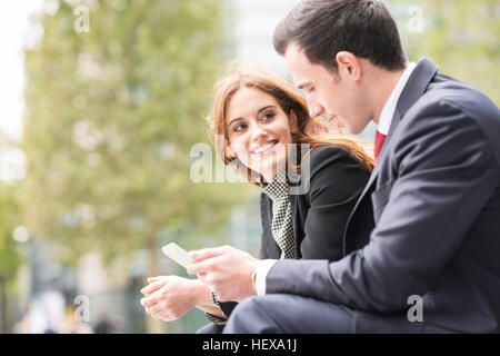 Businesspeople in city using digital tablet Stock Photo