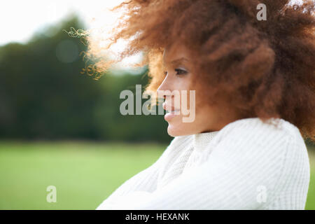 Portrait of curly haired woman looking away