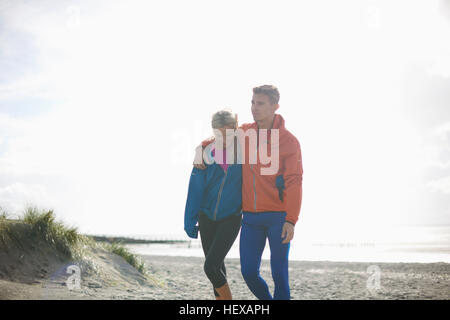 Couple walking together on beach Stock Photo