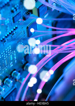 Fibre optics shooting past electronics of broadband hub Stock Photo