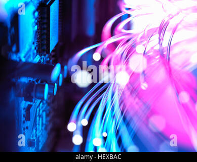 Cyber attack with fibre optics shooting past electronics of broadband hub Stock Photo